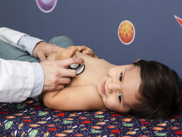 Doctor examining the kid using stethoscope