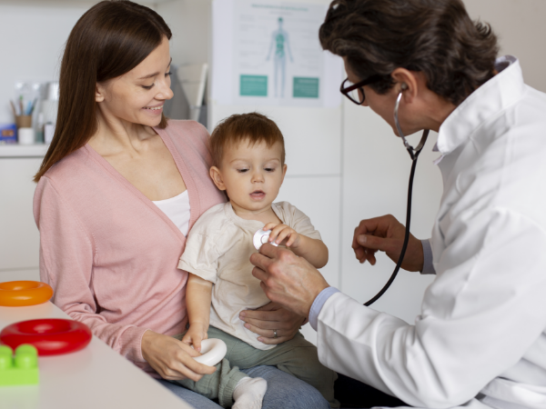 Doctor examining the kid using stethoscope